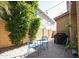Charming backyard featuring paver patio, dining set, lush landscaping, and string lights at 1950 W Park Pl, Chandler, AZ 85224