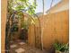 Enclosed backyard with rock landscaping, a wrought iron arbor, and a block wall at 1950 W Park Pl, Chandler, AZ 85224