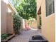 A nicely landscaped backyard with red patio furniture and a modern fire pit at 1950 W Park Pl, Chandler, AZ 85224