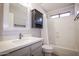 This bathroom features a single sink vanity, framed mirror, and shower over tub with curtain at 1950 W Park Pl, Chandler, AZ 85224
