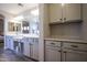 This primary bathroom features a double sink vanity, wood-look tile floors, and built in storage at 1950 W Park Pl, Chandler, AZ 85224