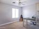 This room features neutral walls, ceiling fan, carpet, desk and chair at 1950 W Park Pl, Chandler, AZ 85224