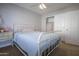 Cozy bedroom showcasing a white metal bed frame, neutral walls, and closet with sliding doors at 1950 W Park Pl, Chandler, AZ 85224