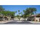 Gated community entrance featuring mature trees and lush landscaping in a desirable neighborhood at 1950 W Park Pl, Chandler, AZ 85224