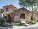 Charming tan two-story home featuring a covered front porch and well-maintained landscaping at 1950 W Park Pl, Chandler, AZ 85224