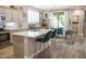 Open-concept kitchen with an island with seating, modern appliances, and bright natural light at 1950 W Park Pl, Chandler, AZ 85224