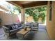 Relaxing covered patio with cushioned seating, a coffee table, and outdoor decor at 1950 W Park Pl, Chandler, AZ 85224