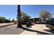 Charming home featuring low maintenance landscaping, driveway, and a mature palm tree at 201 S Greenfield Rd # 23, Mesa, AZ 85206