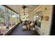 Relaxing enclosed patio with comfortable wicker furniture and ceiling fans for outdoor enjoyment at 201 S Greenfield Rd # 23, Mesa, AZ 85206