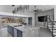 Open-concept kitchen with a large island, backyard views, and a modern staircase at 20274 N 76Th Way, Scottsdale, AZ 85255