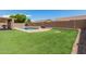 Artificial grass backyard featuring pool, privacy fence, and desert landscaping at 20427 N 88Th Dr, Peoria, AZ 85382