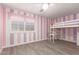room featuring a loft bed with a desk, striped walls and a window at 20427 N 88Th Dr, Peoria, AZ 85382