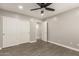 Bedroom features neutral tones, wood-look floors, a closet with slider doors and a entry door at 20427 N 88Th Dr, Peoria, AZ 85382