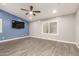 Stylish bedroom featuring a ceiling fan, plantation shutters, and contemporary design at 20427 N 88Th Dr, Peoria, AZ 85382
