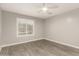 Cozy bedroom features neutral tones, wood-look floors, ceiling fan and a window with plantation shutters at 20427 N 88Th Dr, Peoria, AZ 85382