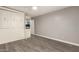 Bright bedroom featuring a Murphy bed, wood-look floors, neutral tones and a closet at 20427 N 88Th Dr, Peoria, AZ 85382