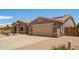 Single-story home featuring desert landscaping, solar panels, and a three car garage at 20427 N 88Th Dr, Peoria, AZ 85382