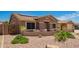Single-story home featuring desert landscaping, solar panels, and a welcoming front porch at 20427 N 88Th Dr, Peoria, AZ 85382