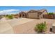 Single-story home featuring desert landscaping, solar panels, and a three car garage at 20427 N 88Th Dr, Peoria, AZ 85382