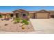 Charming single-story home with desert landscaping and a three car garage at 20427 N 88Th Dr, Peoria, AZ 85382