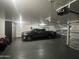 Spacious garage with epoxy floors and storage for vehicles and equipment at 20427 N 88Th Dr, Peoria, AZ 85382