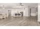 Spacious open-plan kitchen featuring white cabinets, stainless steel appliances, and a large central island at 20427 N 88Th Dr, Peoria, AZ 85382
