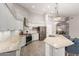Well-lit kitchen with white cabinets, stainless steel appliances, and a center island with a breakfast bar at 20427 N 88Th Dr, Peoria, AZ 85382