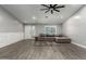 Comfortable living room featuring wood-look floors and a large sectional couch at 20427 N 88Th Dr, Peoria, AZ 85382