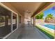 Covered patio with ceiling fans overlooking the pool and backyard at 20427 N 88Th Dr, Peoria, AZ 85382