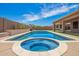 Inviting pool and spa surrounded by a patio and lush landscaping at 20427 N 88Th Dr, Peoria, AZ 85382