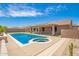 Backyard oasis featuring pool, spa, and desert landscape at 20427 N 88Th Dr, Peoria, AZ 85382