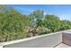 Scenic balcony view showcasing lush greenery and desert landscaping under a clear blue sky at 20802 N Grayhawk Dr # 1123, Scottsdale, AZ 85255
