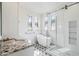 Bright bathroom showcasing a freestanding tub, glass shower, patterned floors, and ample natural light at 20802 N Grayhawk Dr # 1123, Scottsdale, AZ 85255