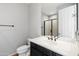 Neutral-toned bathroom with a black vanity and framed mirror at 20802 N Grayhawk Dr # 1123, Scottsdale, AZ 85255