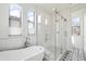 Bathroom featuring a modern freestanding tub, glass-enclosed shower, and patterned tile floors at 20802 N Grayhawk Dr # 1123, Scottsdale, AZ 85255