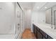 Bathroom featuring a shower with glass doors, a bathtub, and a vanity with ample storage at 20802 N Grayhawk Dr # 1123, Scottsdale, AZ 85255