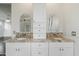 Bathroom with a double vanity with stone countertops and framed mirrors at 20802 N Grayhawk Dr # 1123, Scottsdale, AZ 85255