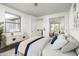 Bright bedroom featuring decor, an ensuite bathroom, and large windows at 20802 N Grayhawk Dr # 1123, Scottsdale, AZ 85255