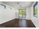Spacious bedroom with gleaming hardwood floors and a sliding glass door to a balcony at 20802 N Grayhawk Dr # 1123, Scottsdale, AZ 85255