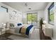 Beautifully decorated bedroom with a sliding glass door for balcony access and natural light at 20802 N Grayhawk Dr # 1123, Scottsdale, AZ 85255