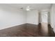 Spacious bedroom with fan, neutral walls, wood floor, and views of closet and hallway at 20802 N Grayhawk Dr # 1123, Scottsdale, AZ 85255