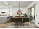 Chic dining space featuring a stylish chandelier, wood table, and access to outdoor patio at 20802 N Grayhawk Dr # 1123, Scottsdale, AZ 85255