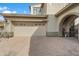 Exterior view showcasing a two-car garage and gated walkway for a private entrance at 20802 N Grayhawk Dr # 1123, Scottsdale, AZ 85255