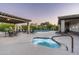 Community pool with hot tub, covered seating areas, and lounging options at 20802 N Grayhawk Dr # 1123, Scottsdale, AZ 85255