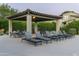 Outdoor seating areas with lounge chairs and tables surround the community pool at 20802 N Grayhawk Dr # 1123, Scottsdale, AZ 85255