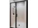 Modern shower featuring a sleek, black frame and convenient shelving at 20802 N Grayhawk Dr # 1123, Scottsdale, AZ 85255