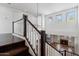 Open staircase overlooking the living room, fireplace, and windows providing lots of natural light at 20802 N Grayhawk Dr # 1123, Scottsdale, AZ 85255