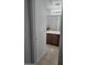 Bathroom featuring a wooden vanity and tub with a sliding glass shower door at 20941 N Leona Blvd, Maricopa, AZ 85138
