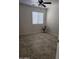 Neutral bedroom with tile floors, ceiling fan, and a bright window at 20941 N Leona Blvd, Maricopa, AZ 85138