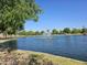 Picturesque community lake view, showcasing fountain feature at 20941 N Leona Blvd, Maricopa, AZ 85138